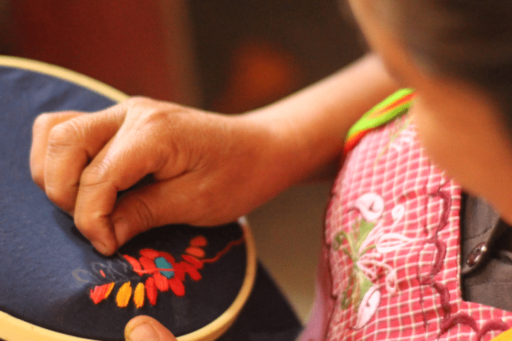 A woman does embroidery