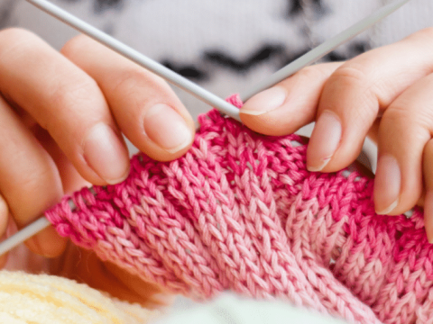 Close up photo of hands knitting at Southern Grove Knitting Club