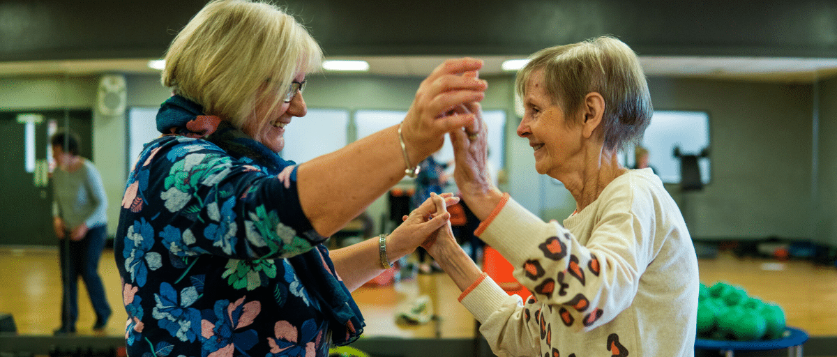 Two senior aged women dancing together at the Linc Community Centre